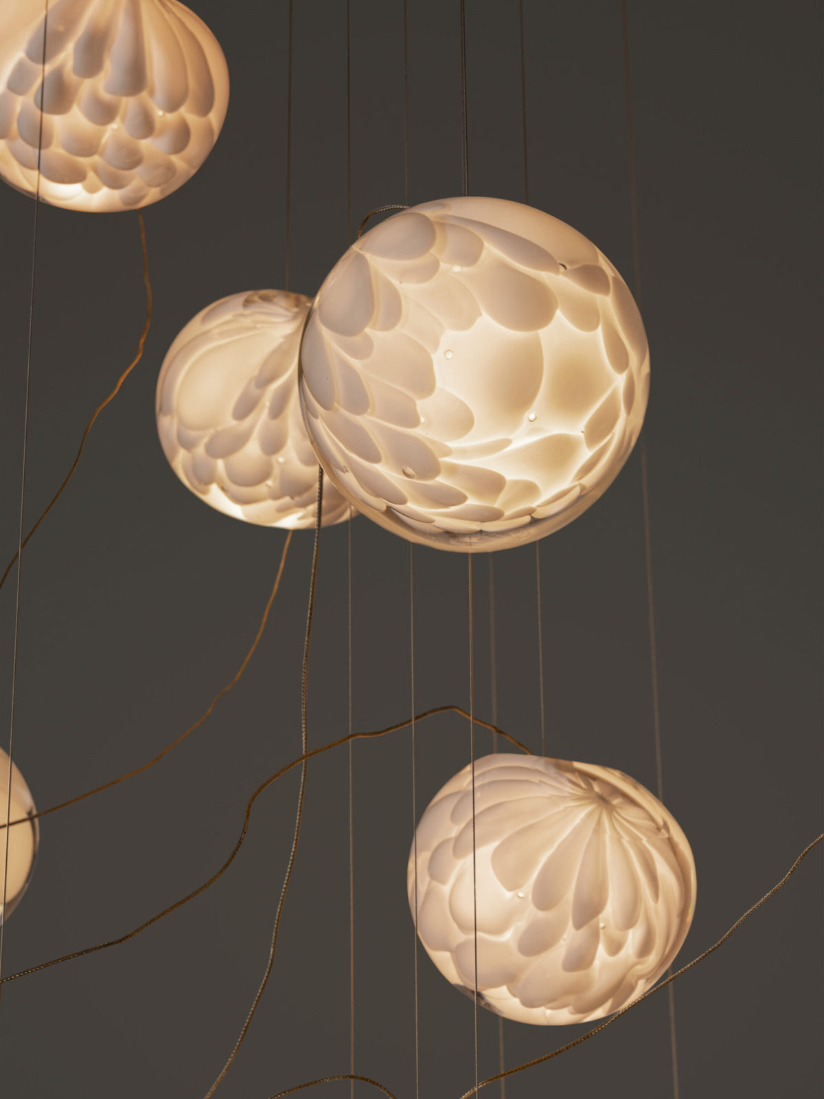 Detalj av Bocci 118.7 lampe med skulpturell kabel og håndblåste glasskuler, designet for å skape et poetisk lysuttrykk